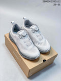 White and grey DESCENTE running shoes with dial closures displayed on a branded box.