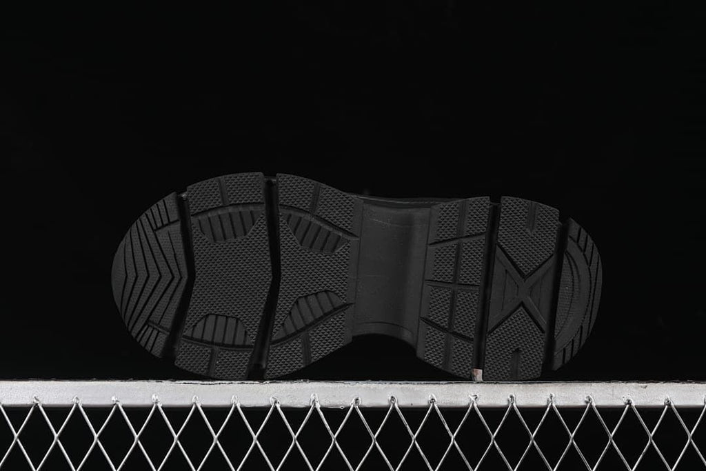 Underside of the sneaker showing the black outsole tread.
