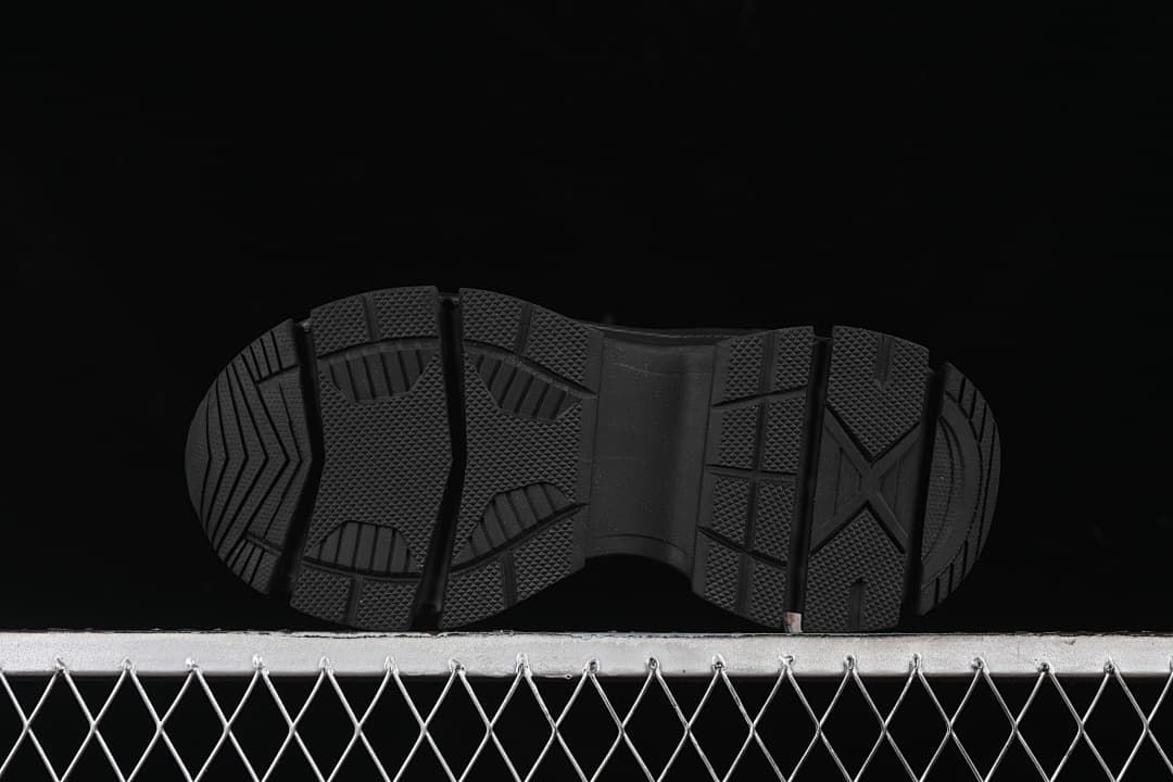 Underside of the sneaker showing the black outsole tread.