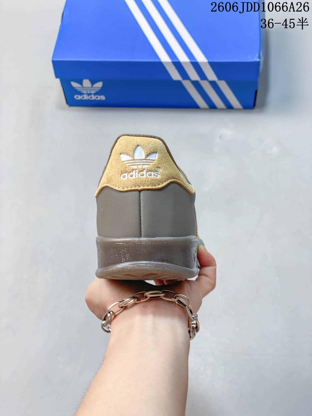 Rear view showing the gold-tone heel detail and grey outsole