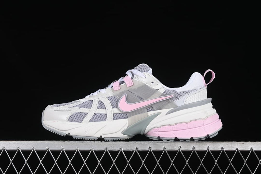 Side view of the white, grey, and pink Nike V2K Run sneaker.
