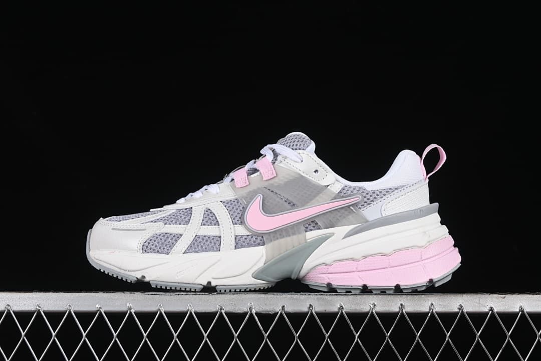 Side view of the white, grey, and pink Nike V2K Run sneaker.