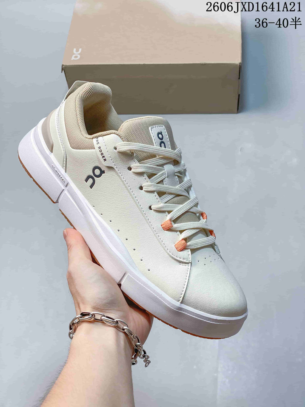 Cream On The Roger low-top sneaker with tan outsole accents and orange lace details