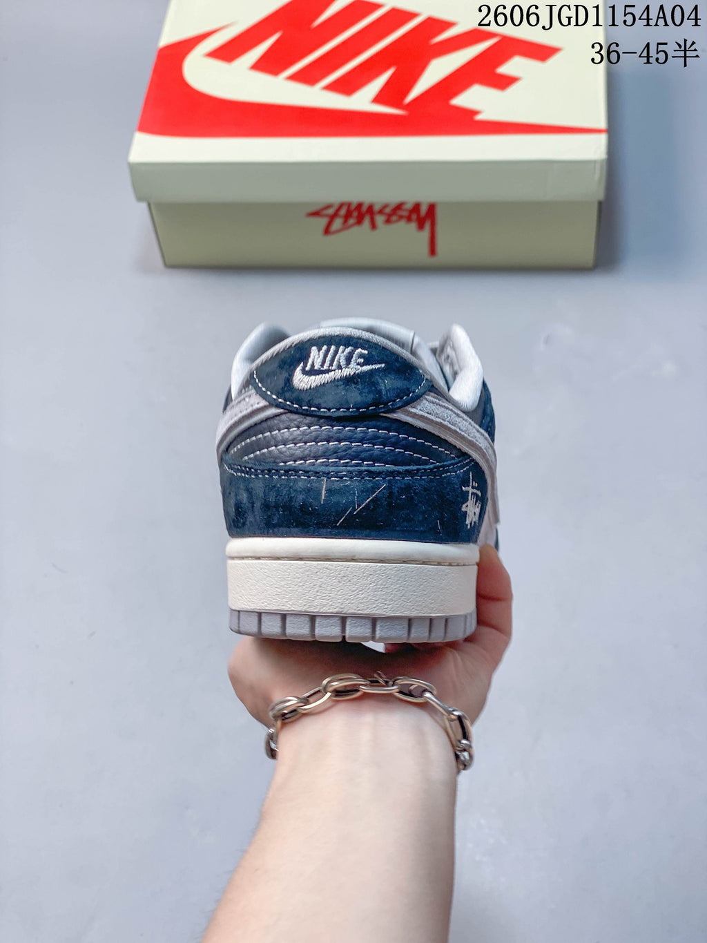 Rear view of a blue and grey low-top sneaker