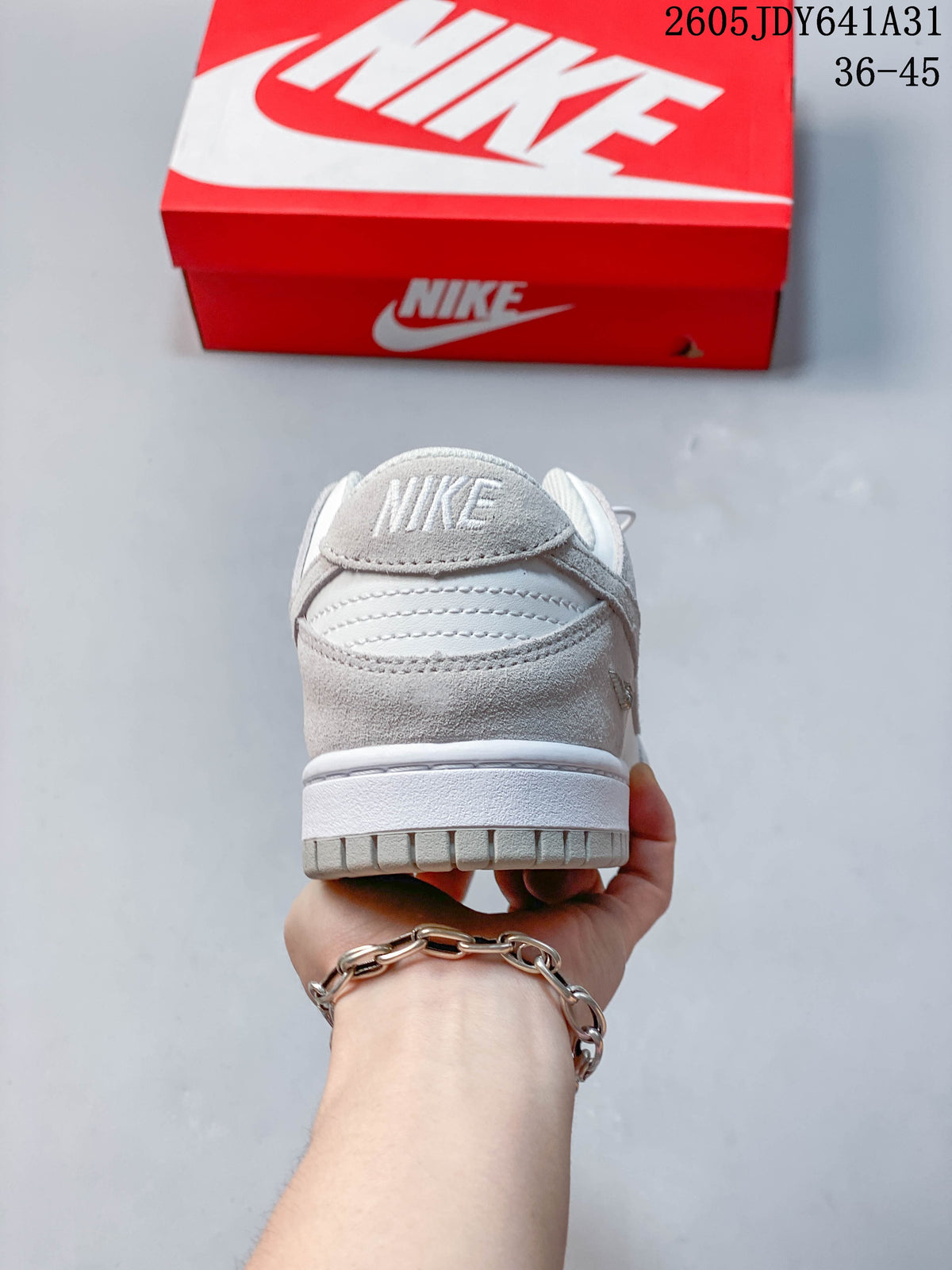 Rear view of a low-top sneaker showing grey heel panels and white midsole