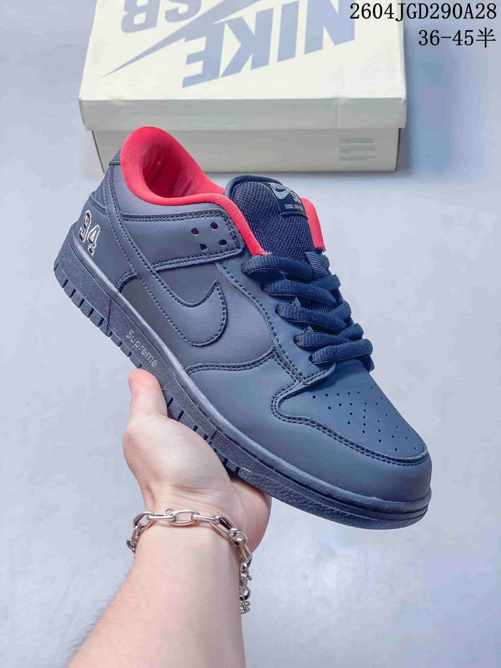 Charcoal low-top sneaker with navy laces and bright red lining