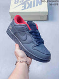 Charcoal low-top sneaker with navy laces and bright red lining