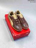 Pair of brown and beige PUMA Club II Era low-top sneakers on a red shoe box