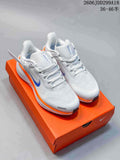Pair of white Nike Pegasus 41 running shoes with blue Swooshes and orange accents on an orange shoe box.