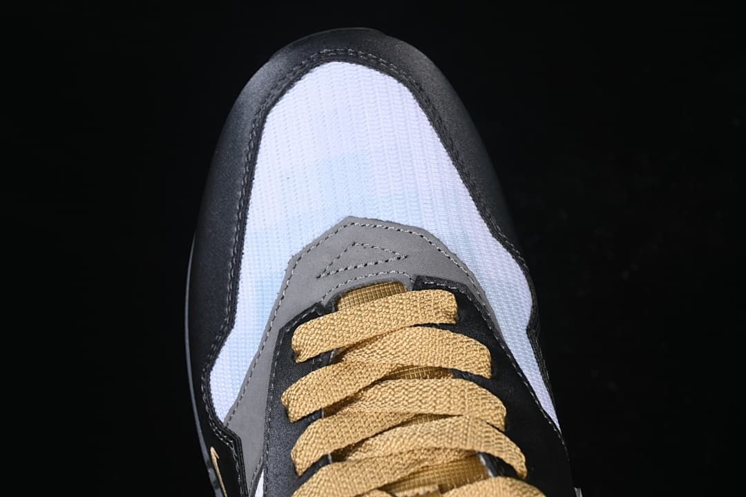 Top-down view of the toe box and gold-tone laces
