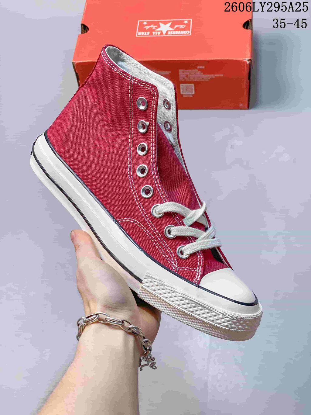 Deep red Converse high-top lace-up sneaker with a white toe cap and striped sole