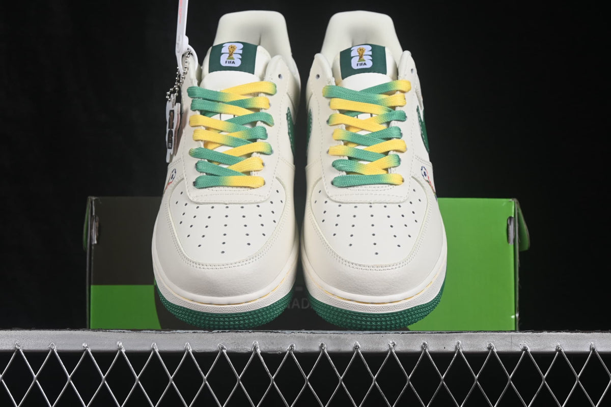 Front view of the pair positioned over the green shoebox, highlighting the perforated toe boxes and colored laces.