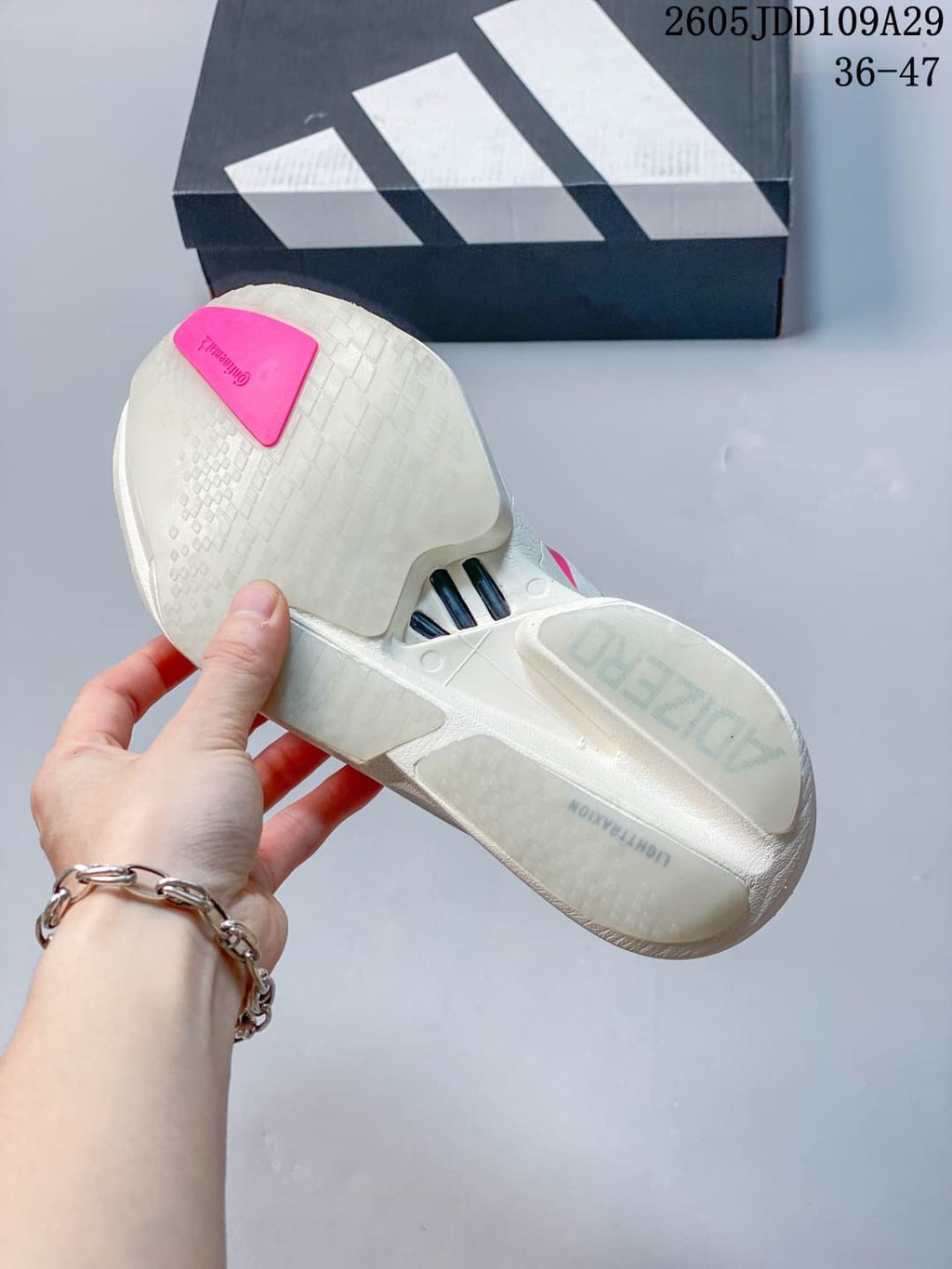 Underside view showing the textured white outsole and pink outsole detail.