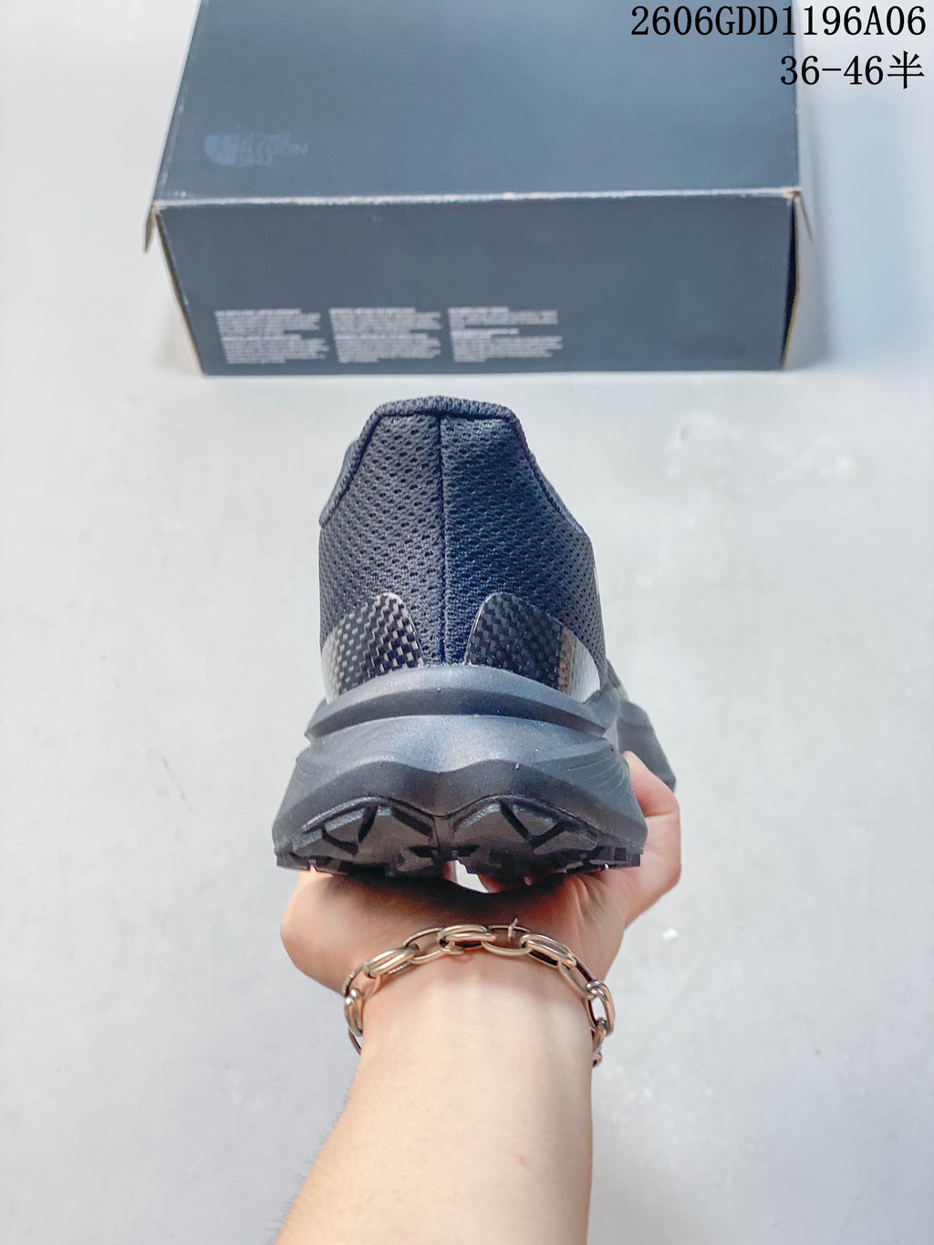 Rear view showing the heel and outsole of a gray trail shoe