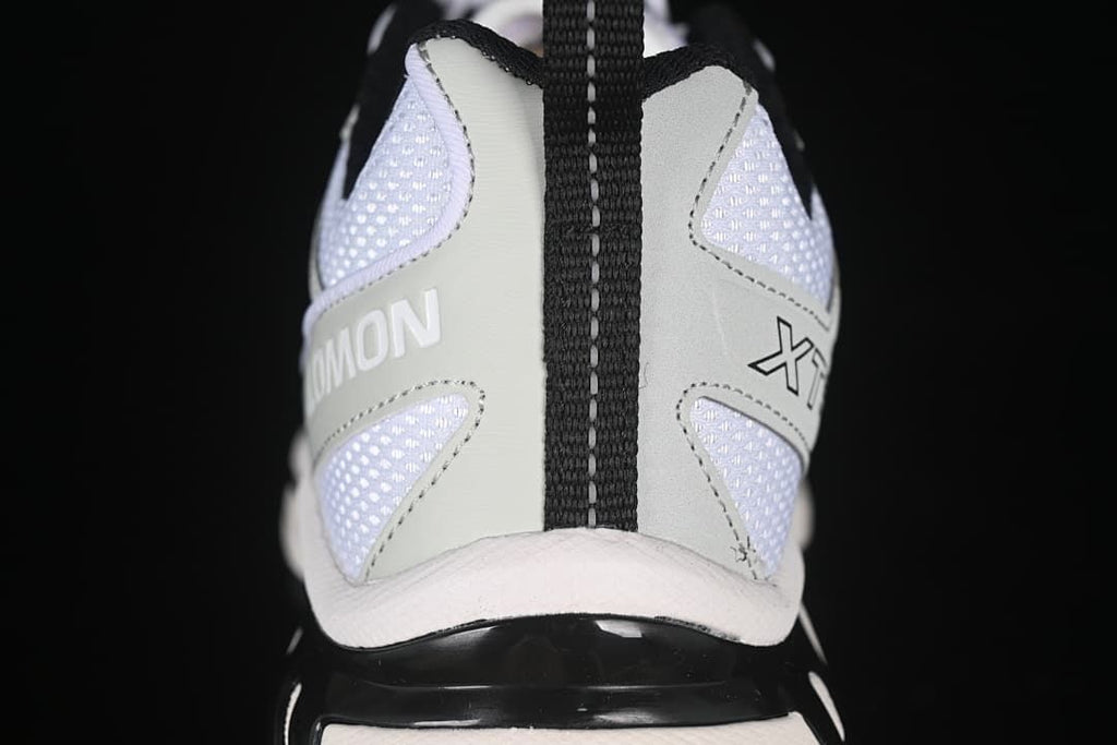 Rear view showing the heel pull loop, mesh panels, and Salomon branding.