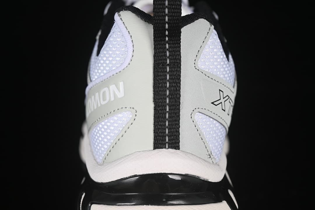 Rear view showing the heel pull loop, mesh panels, and Salomon branding.