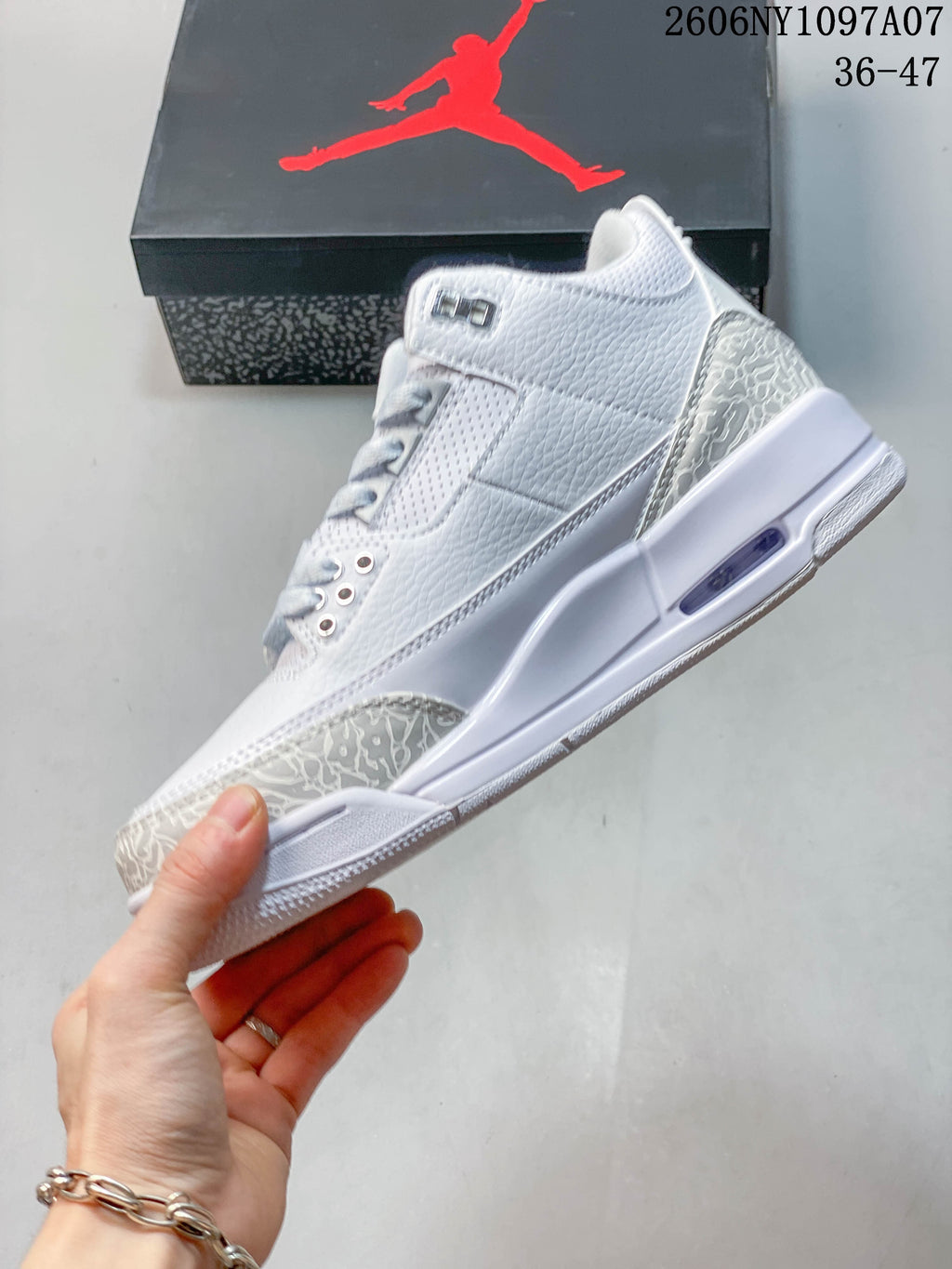 Side view of the white and grey mid-top sneaker