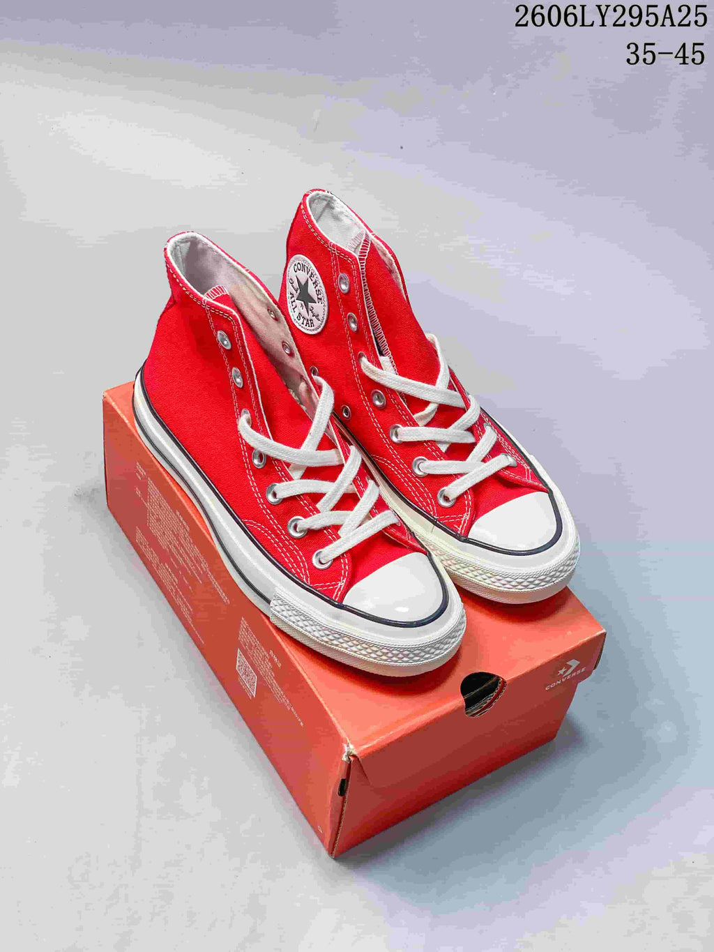 Pair of red Converse Chuck Taylor All Star 1970 high-top sneakers on a red shoe box