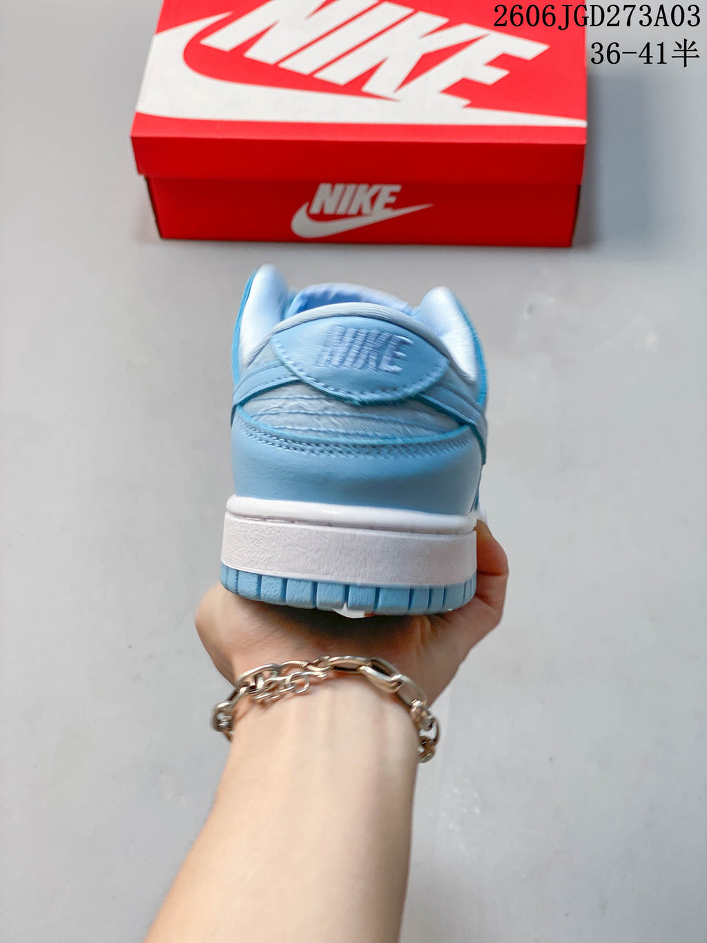 Rear view showing the heel, white midsole, and blue outsole