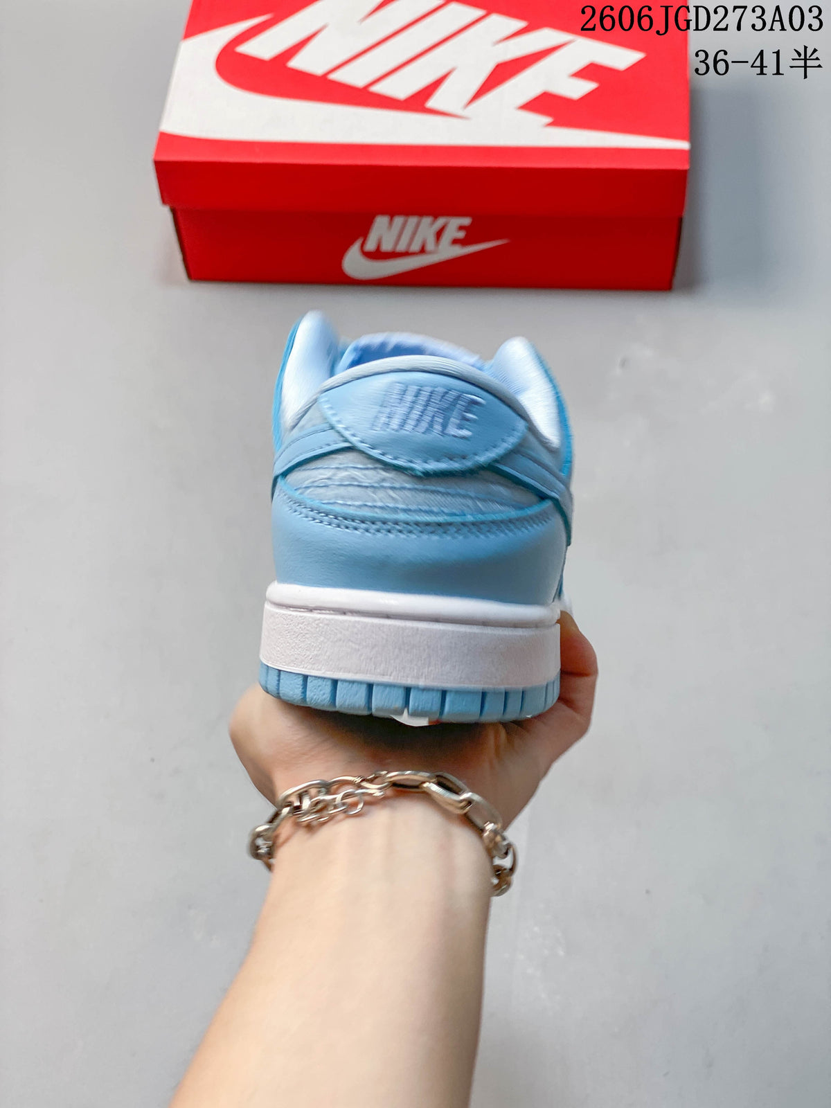 Rear view showing the heel, white midsole, and blue outsole