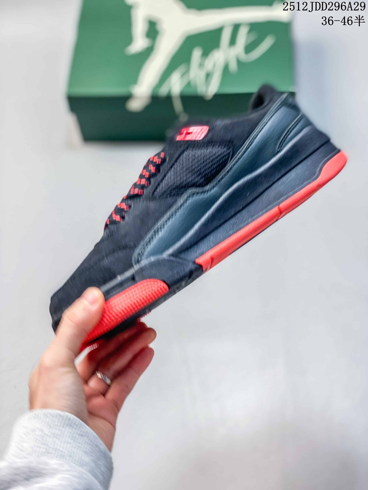Side profile of a black sneaker with red outsole accents