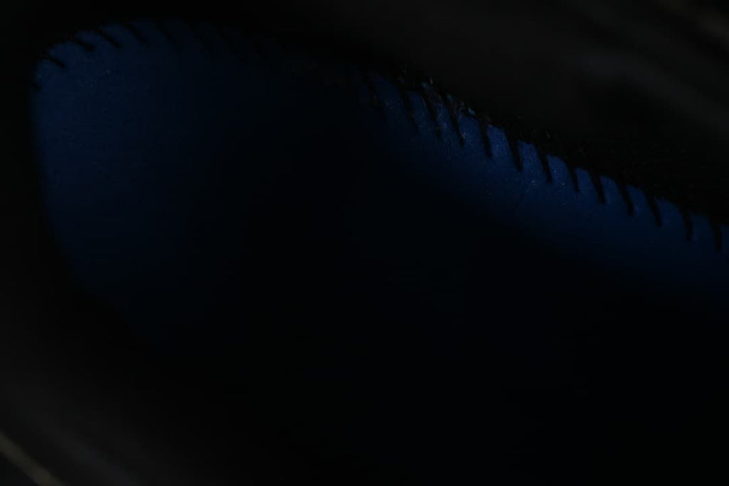 Dark close-up of the shoe's side construction