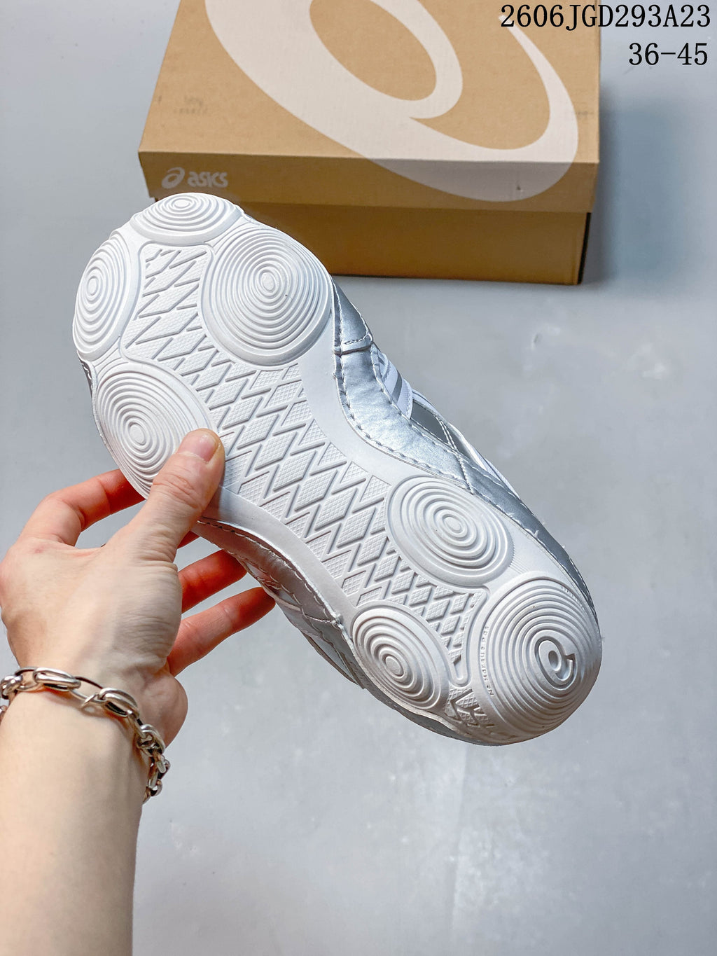 Close-up of the white outsole with circular tread patterns.