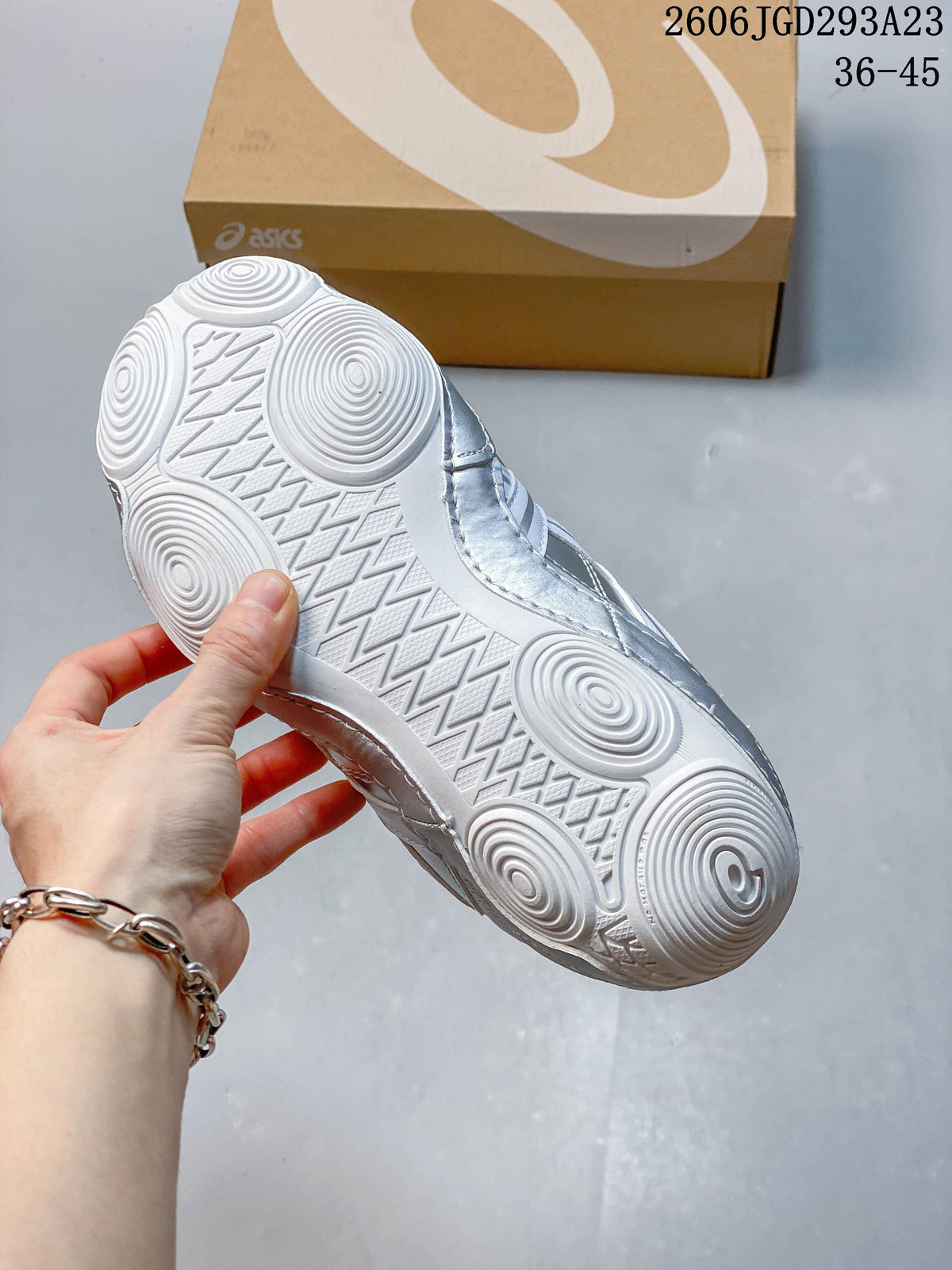 Close-up of the white outsole with circular tread patterns.
