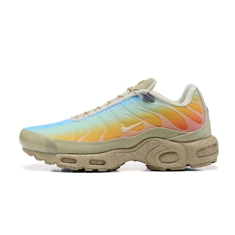 Multicolor Nike Air Max Plus sneaker fading from blue to yellow and pink, with a light-colored sole.