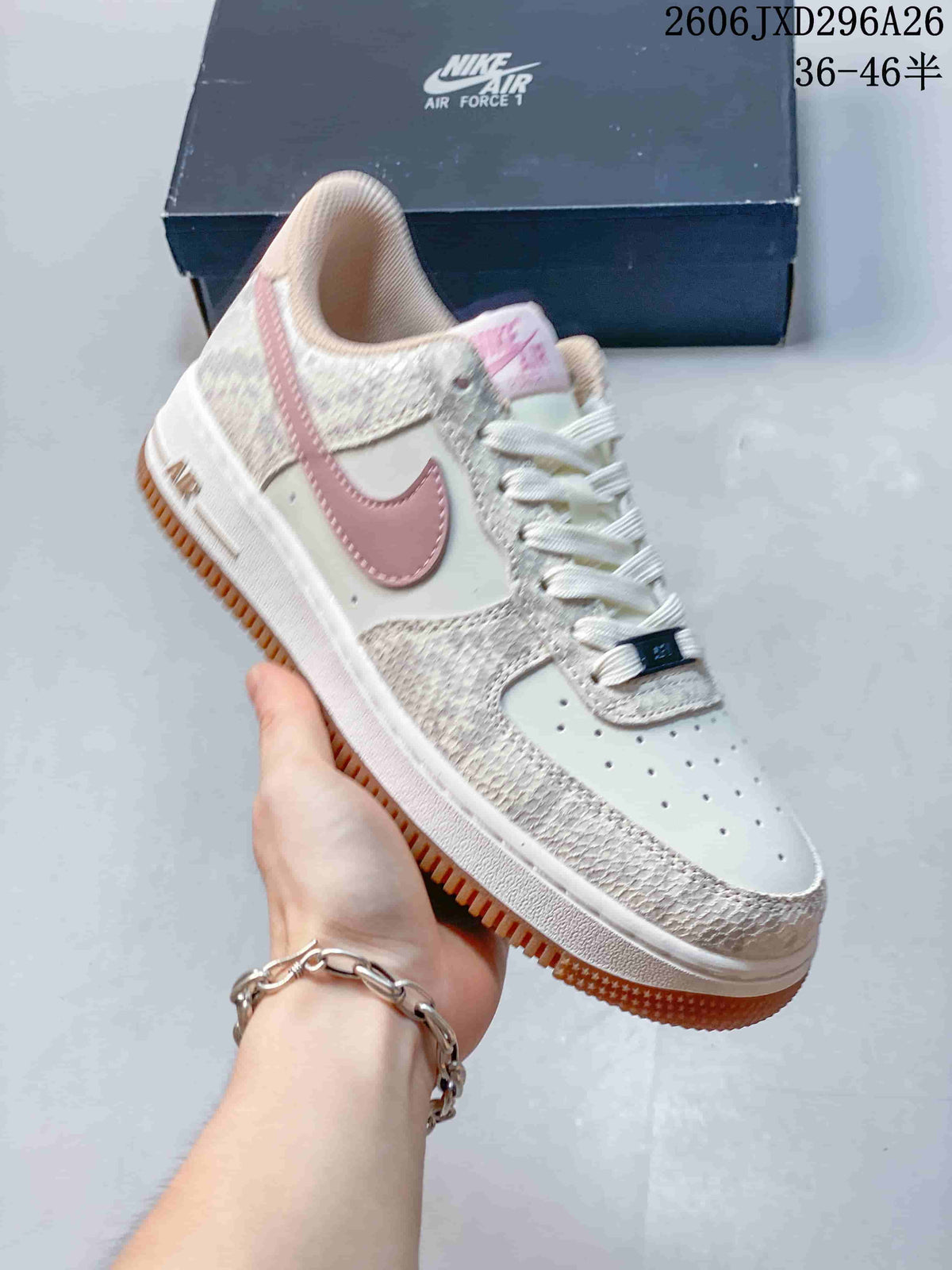 Close-up of a white Nike Air Force 1 sneaker with pink Swoosh and patterned overlays