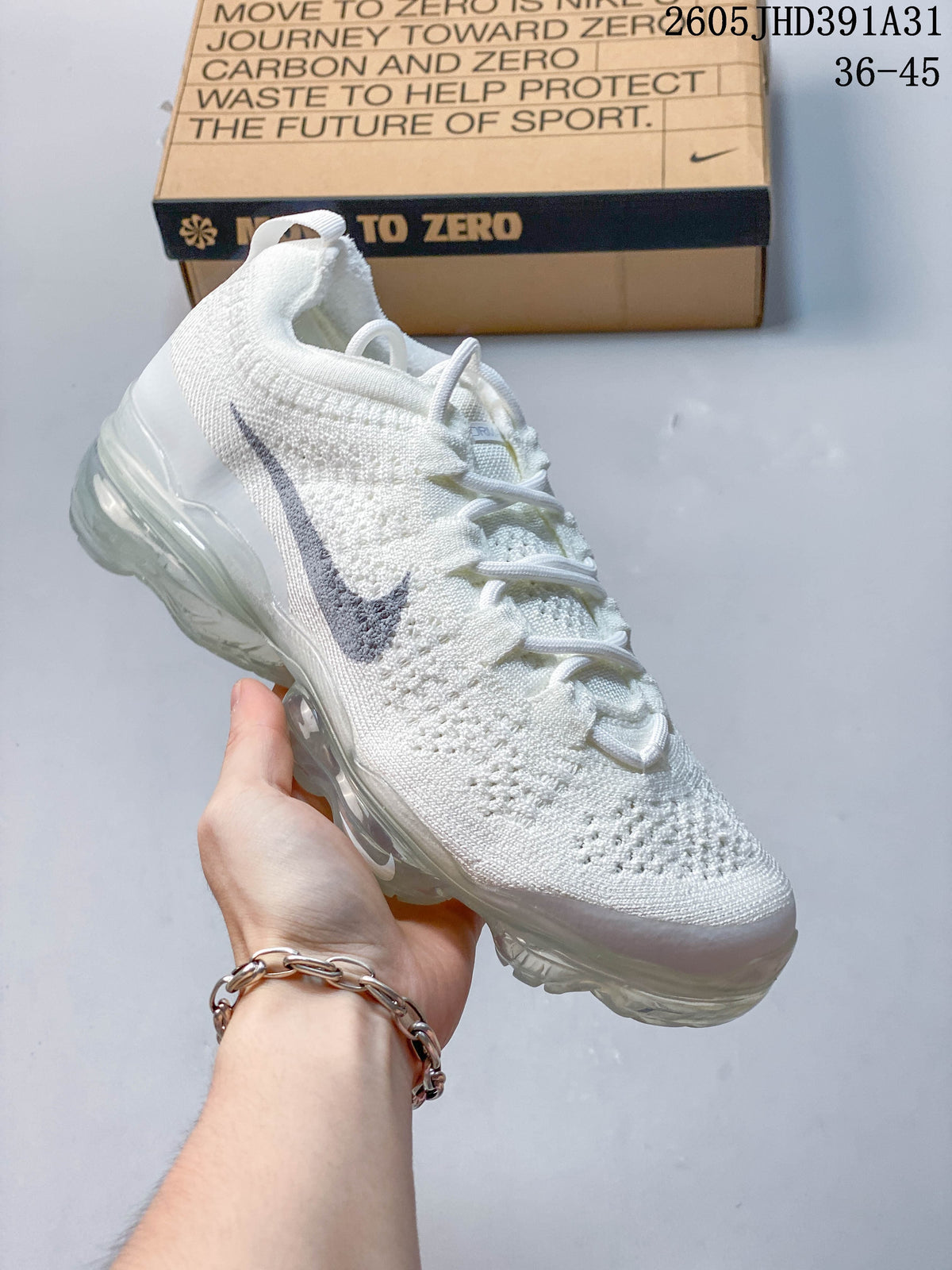 Angled side view of the white knit shoe with gray Swoosh and translucent sole.