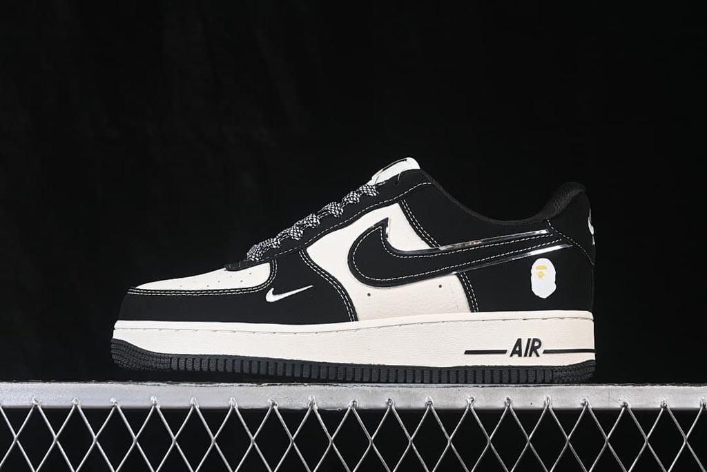 Side view showing the black and off-white sneakers, small heel graphic, and AIR midsole marking.