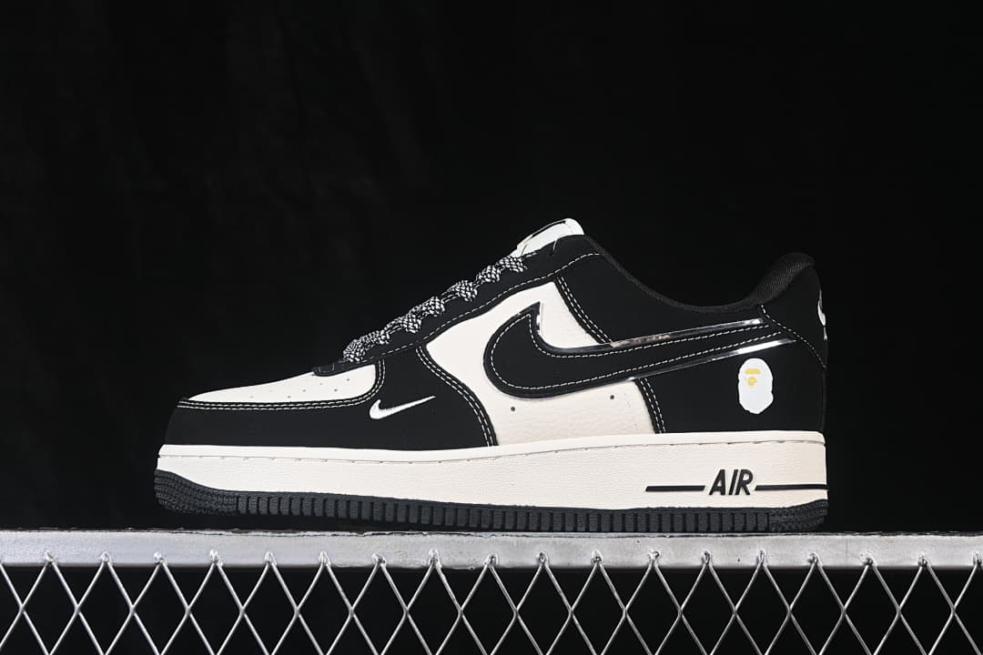 Side view showing the black and off-white sneakers, small heel graphic, and AIR midsole marking.