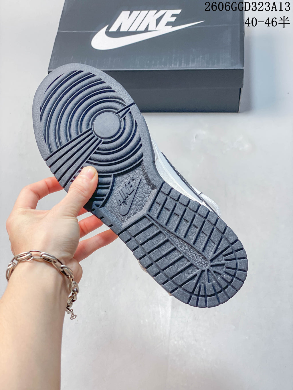 Close-up of the dark navy textured outsole on a white and navy low-top sneaker