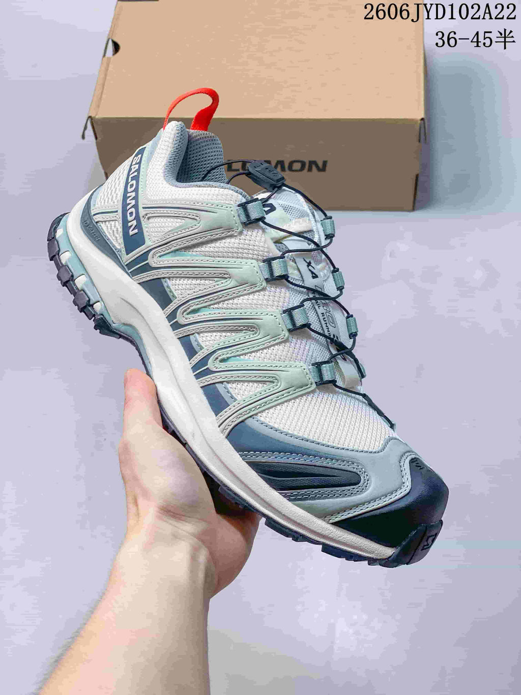 Light-colored Salomon XA Pro 3D sneaker with pale blue-green details and a lugged outsole