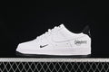 Side view of a white and black Nike Air Force 1 '07 Low with Undefeated script on the heel-side panel