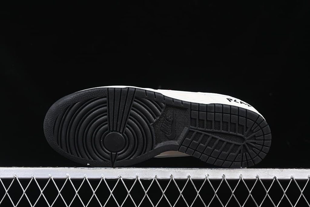 View of the black rubber outsole and circular forefoot tread