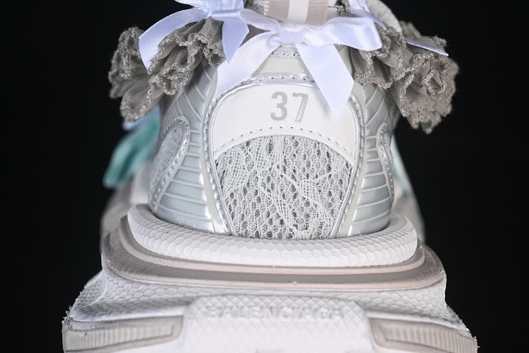 Rear view of the sneaker showing the EU 37 marking, lace bows, and gray ruffle trim