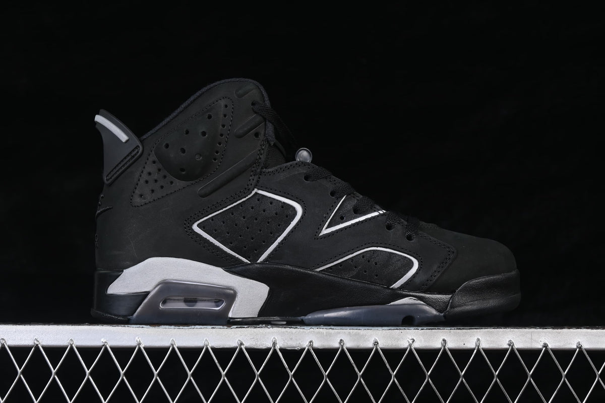 Side view of a black Air Jordan 6 Retro sneaker with light-colored panel trim and heel accents.