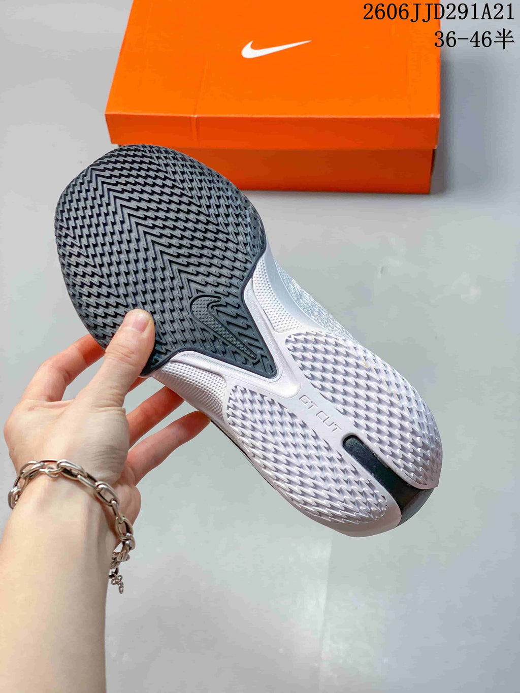 Close-up of the patterned outsole on a white Nike G.T. Cut 3 EP shoe.