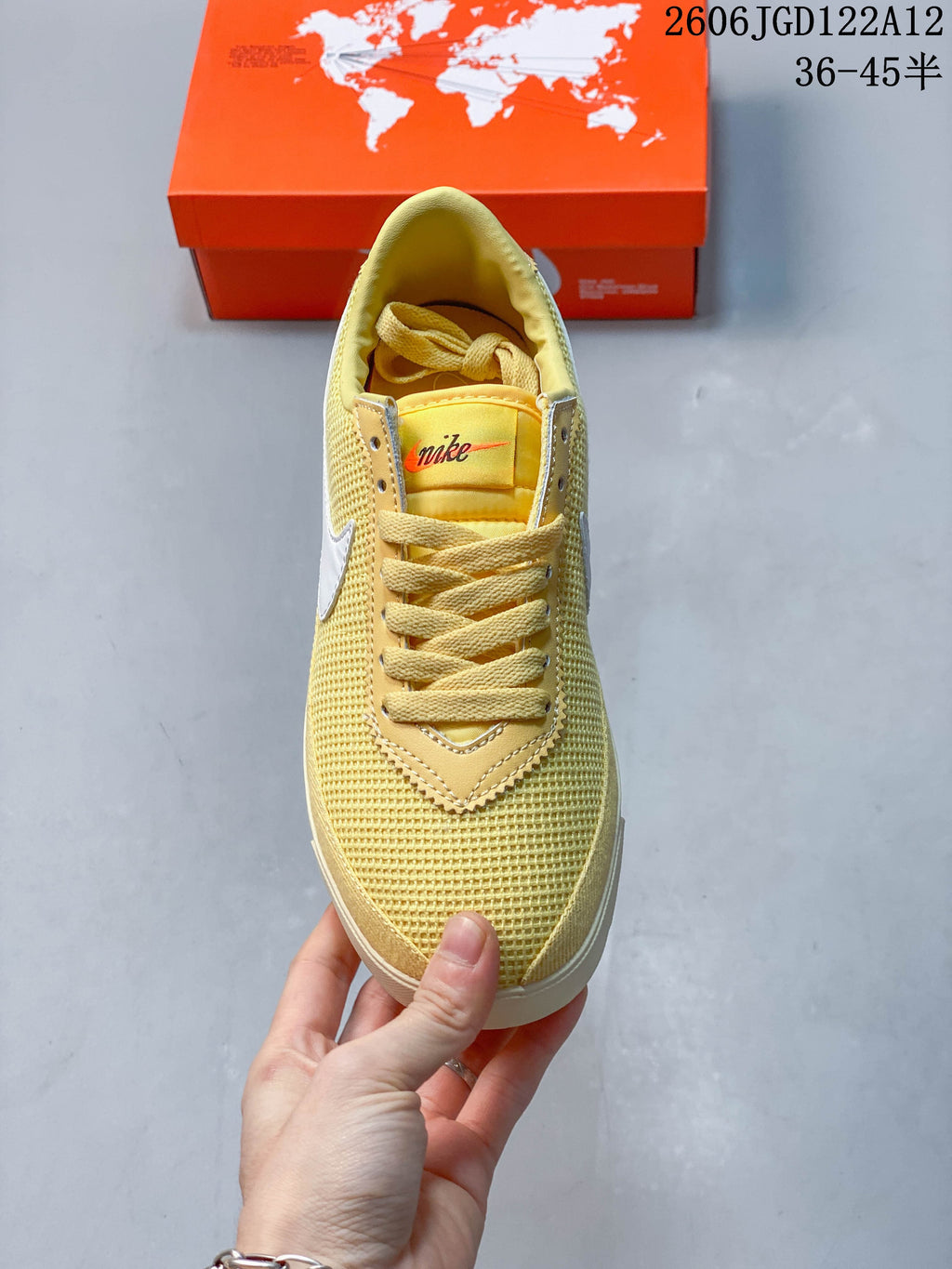Top view of a pale yellow Nike Astro Grabber sneaker with matching laces and a textured toe.