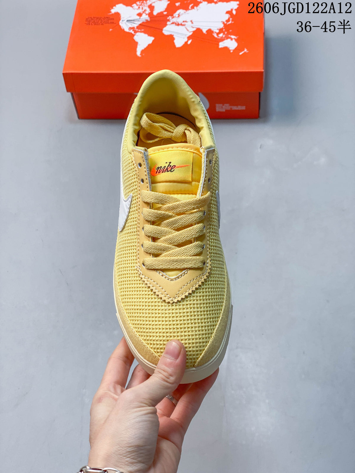 Top view of a pale yellow Nike Astro Grabber sneaker with matching laces and a textured toe.