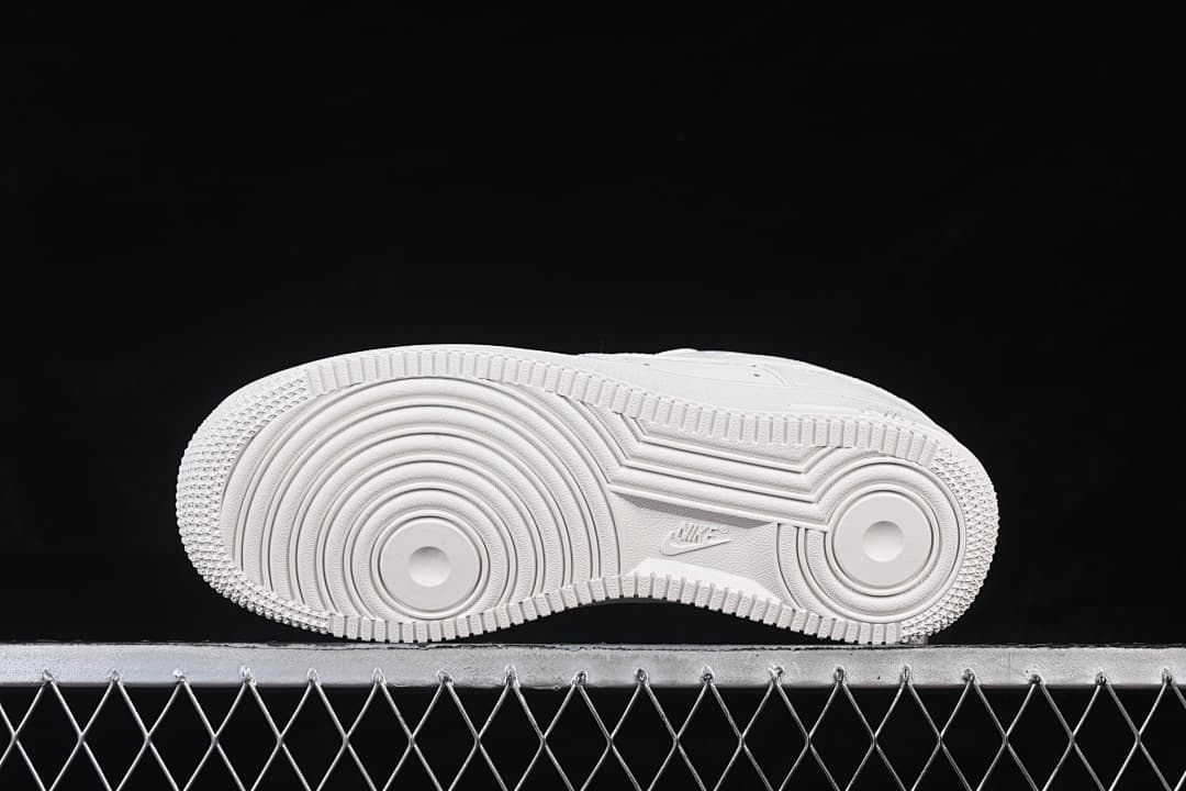 Underside view showing the circular tread pattern on the white outsole