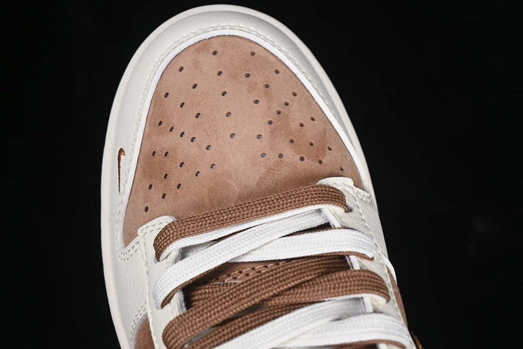 Top close-up of perforated brown toe box and mixed-color laces