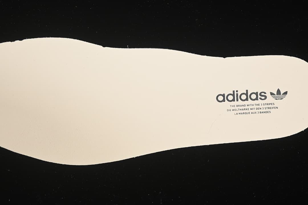 Adidas-branded light-colored shoe insert.