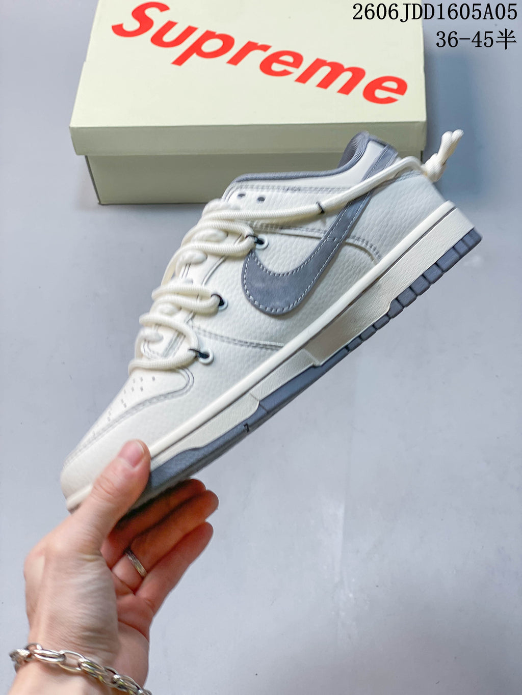 Side view of the off-white sneaker with grey accents