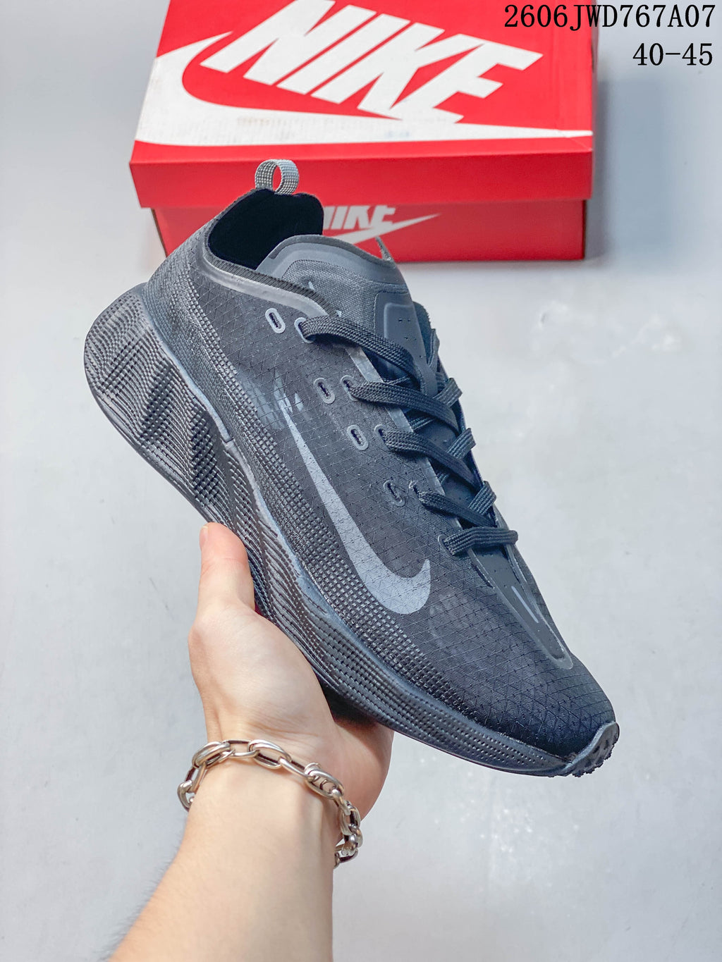 Side view of a charcoal Nike Ava Rover shoe with a gray Swoosh and textured outsole.
