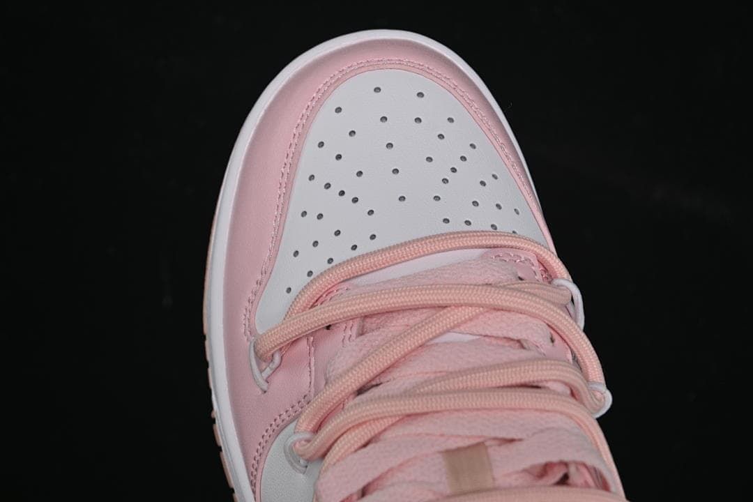 Top view of the perforated white toe and pink lacing.