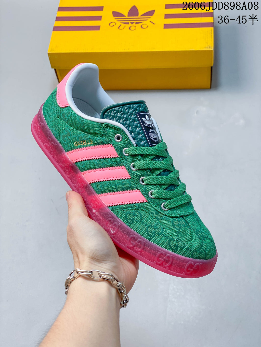 Side view of a green patterned sneaker with pink stripes and a translucent pink outsole