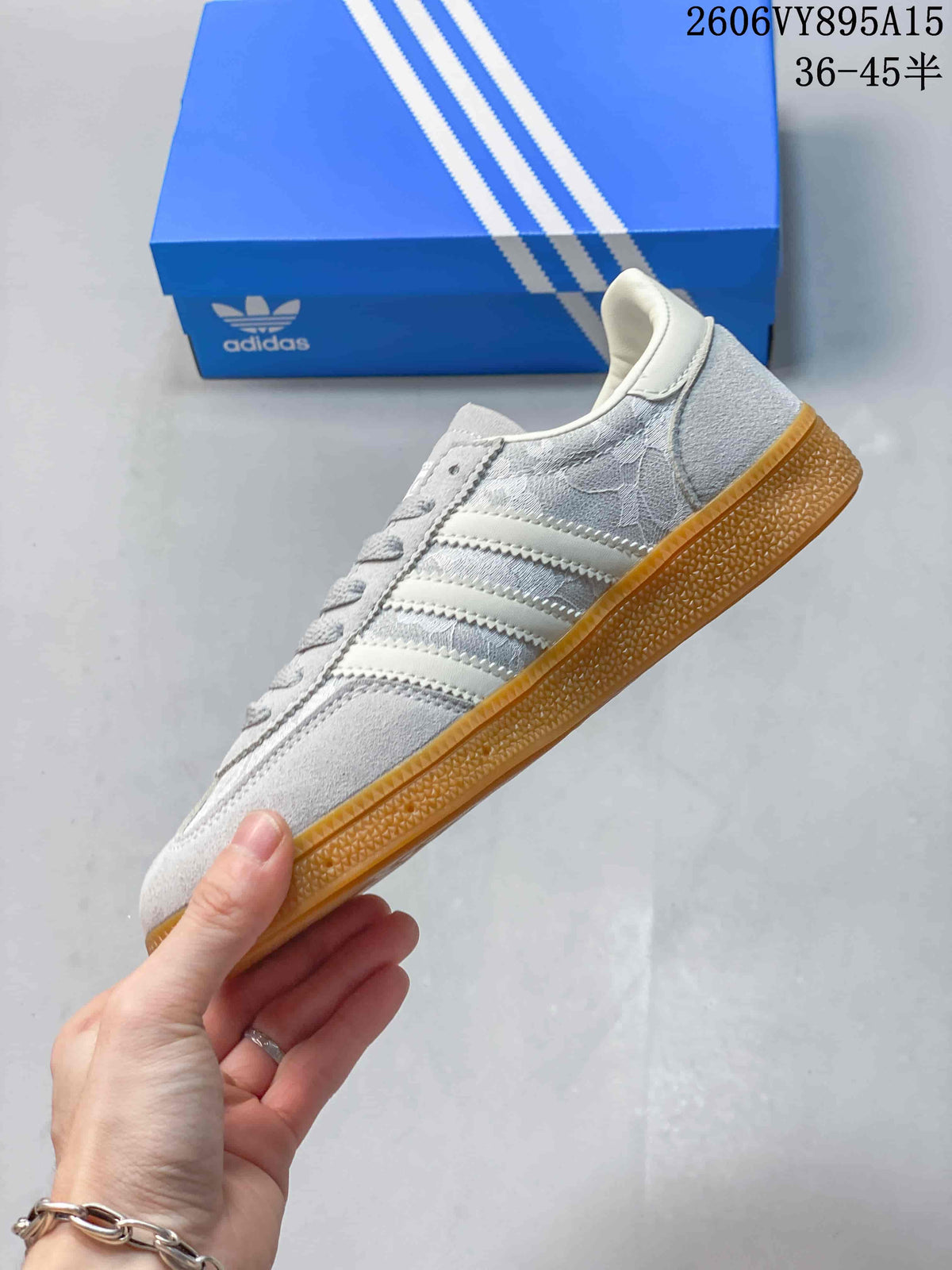 Side profile of the sneaker showing three stripes and a gum-colored outsole